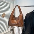 Caramel brown bohemian tassel hobo shoulder bag in shiny finish with bow detail - Brown