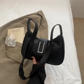 Elegant black pebbled leather shoulder bag with a silver rectangular metal buckle - Black