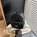 Black quilted backpack with diamond stitching, metal chain straps, and rhinestone accents - Black