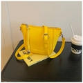 Detail of yellow lychee leather bucket bag with silver buckles and fashion embossing - Yellow