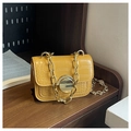 Detail of yellow crocodile pattern handbag with gold metal lock and chain strap - Yellow