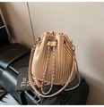 Detail showing vertical pleats on apricot bucket bag with silver metal drawstring chain - Khaki