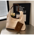 Macro shot of straw tote bag interior with brown leather strap and small pouch - Off White