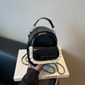 Glossy black mini backpack featuring white lace trim and a bow with silver chain strap - Black