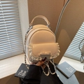 Mini cream beige chain backpack featuring a leather bow and white lace trim detail - Off-white