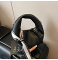 Detail of black pebble leather handbag with paisley silk scarf and metal buckle - Black