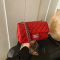 Elegant red quilted crossbody bag with silver chain strap and metallic clasp - Red