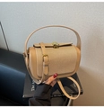 Close-up of beige leather and woven fabric shoulder bag with golden half-moon lock - Khaki