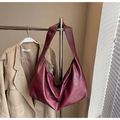 Close-up of wine red hobo bag showing premium leather texture and silver zipper detail - Red