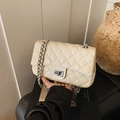 Chic beige quilted chain crossbody bag with silver twist lock and woven leather strap - White
