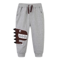 Kids light grey cotton joggers featuring a brown dinosaur embroidery and drawstring - 7Y / Light Gray