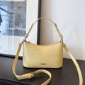 Minimalist light yellow crescent underarm bag with gold metal logo and detachable strap - Yellow