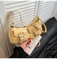 Detail shot of the yellow shoulder bag showing double front pockets and textured faux leather - Yellow
