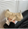 Close-up of off-white baguette bag with multi-pocket design and retro metal buckles - White