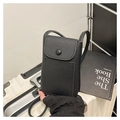 Close-up of black lychee grain leather crossbody phone bag with flap and metal button - Black