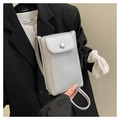 Close-up of silver lychee texture crossbody bag with metal snap and thin shoulder strap - Silver