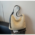 Detail of the woven straw shoulder bag featuring black leather straps and beige texture - Off White
