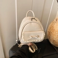 Mini Rucksack in Creme-Weiß mit eleganten Spitzenlagen und einer Lederschleife - Weiß