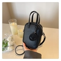Detail of black litchi grain leather mini bag with smiley charm and top handles - Black
