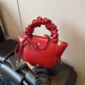 Fashionable dark red pleated mini handbag in shiny leather with a decorative bow tassel - Red