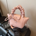 Pink faux leather handbag with pleated cloud handle and decorative side ribbon bow - Pink