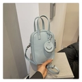 Light blue pebbled leather mini crossbody bag with smiley charm and adjustable strap - Blue