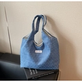 Detail of blue jacquard canvas tote bag with woven texture and metal buckle closure - Blue