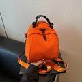 Versatile lightweight bright orange shell-shaped backpack with woven cord handle - Orange