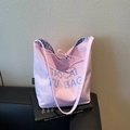 Pink canvas tote bag with blue artistic lettering and checkered lining detail - Pink