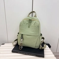 Minimalist light green nylon commute backpack with NMC logo and smiley charm detail - Green