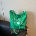 Green canvas tote bag with white lettering and blue plaid lining in minimalist style - Green