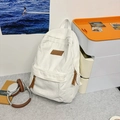 Minimalist white canvas backpack with brown leather logo and large capacity for students - White