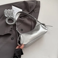 Metallic silver leather shoulder bag with zipper and adjustable strap on a gray blazer - Silver