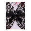 Close-up of black glitter laser-cut lace invitation with a satin bow and floral inner card - Glitter Black
