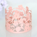 Detail of pink laser-cut floral paper cupcake wrappers with intricate hollow patterns - 4 Inch / Pink