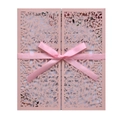 Macro shot of pink laser-cut lace wedding invitation with a silk ribbon bow detail - Light Pink