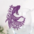 Close-up of laser-cut purple fish paper card with floral patterns for wine glass decor - 9cm / Dark Purple