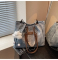 Detail of floral denim tote bag featuring silver chain, pearls and cloud plush charm - Blue