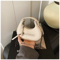Detailed macro view of off-white lychee leather texture and silver zipper of crescent bag - Off White