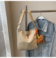 Detail of beige canvas bucket bag with OZBG leather patch and brown plush bear charm - Khaki With Pendant