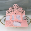 Macro detail of laser-cut pink wedding invitation set with 3D pop-up couple and floral card - Pink