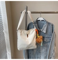 Detail of white canvas bucket bag with brown leather tag and cute bear charm pendant - White With Pendant