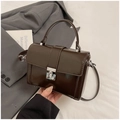 Detailed view of dark brown glossy leather handbag with elegant silver metal lock - Style B Coffee