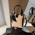 Beige bucket bag with black trim, fashion label, and houndstooth scarf handle detail - White and Black