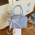 Light blue woven bucket bag with pearl lace bow and adjustable crossbody strap - Blue