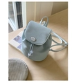 Detailed close-up of light blue mini backpack with lychee grain texture and drawstring - With Charm / Blue