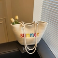Beige woven tote bag with summer embroidery and rope handles in warm natural lighting - Off-white