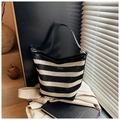 Minimalist black and white striped woven tote bag with a sleek leather shoulder strap - Black