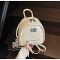 Close-up of a mini beige PU leather backpack with silver metal zippers and top handle - Off-white