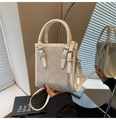 Close-up of bohemian crossbody bag with floral jacquard texture and dual handles - Off White